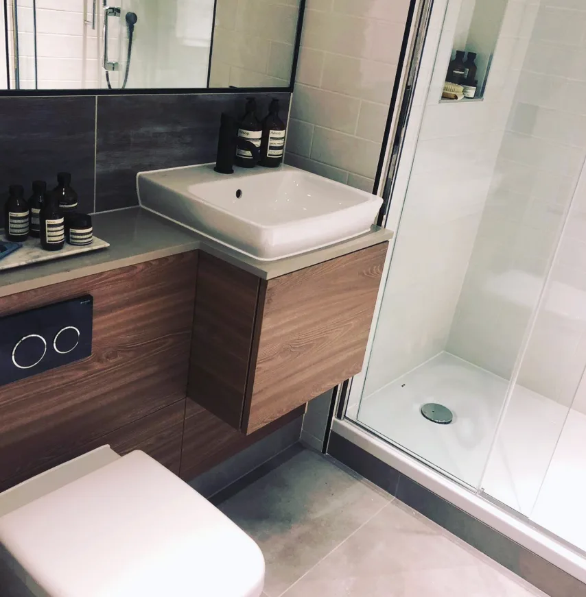 Walnut vanity unit, wall hung toilet and walk in shower